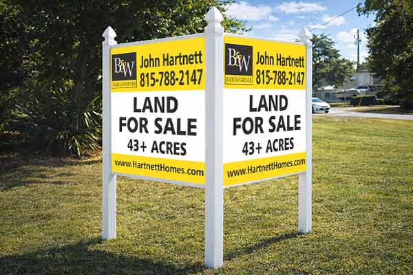 4x4 Baird & Warner sign mounted with Arrow post kit